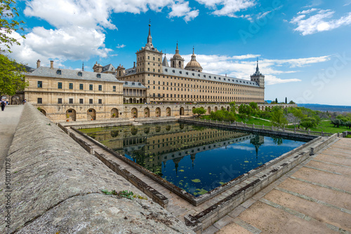 monastery of San Lorenzo de El Escorial with tourists strolling through its gardens and patios in Madrid © josevgluis