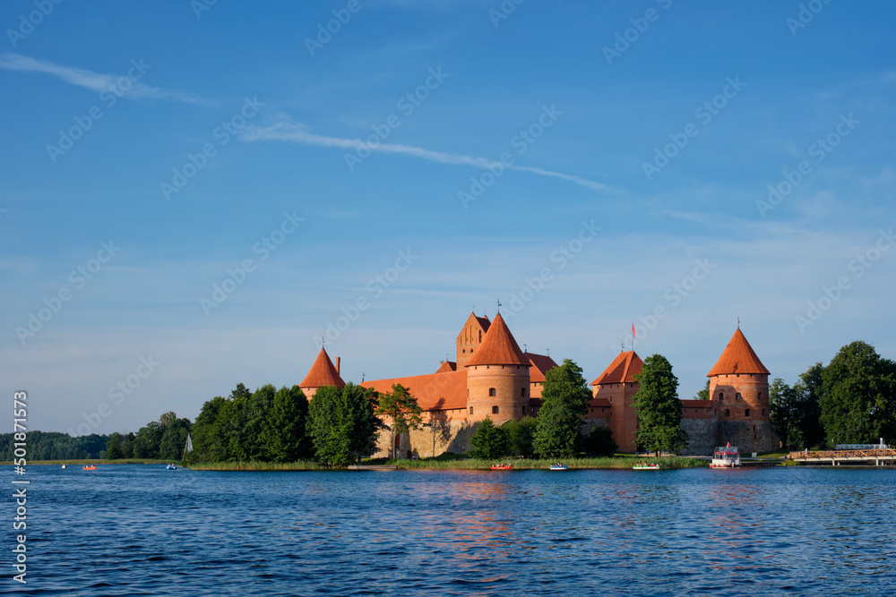 Fototapeta premium Trakai Island Castle in lake Galve with boats in summer day, Lithuania. Trakai Castle is one of major tourist attractions of Lituania