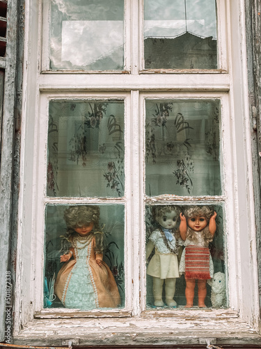 Dolls at window