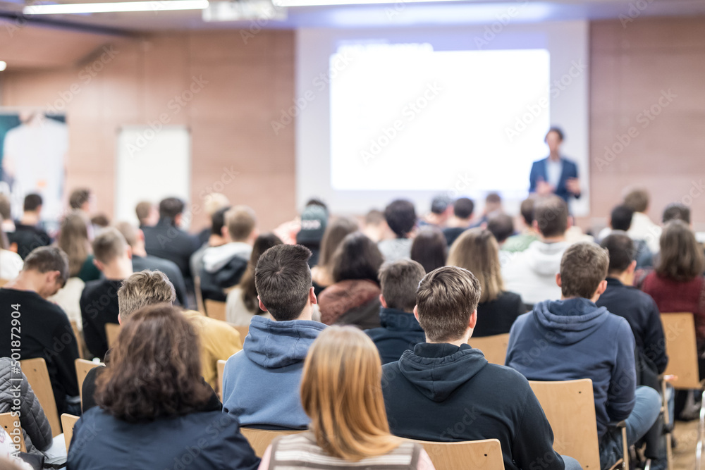 Business speaker giving a talk at business conference event.