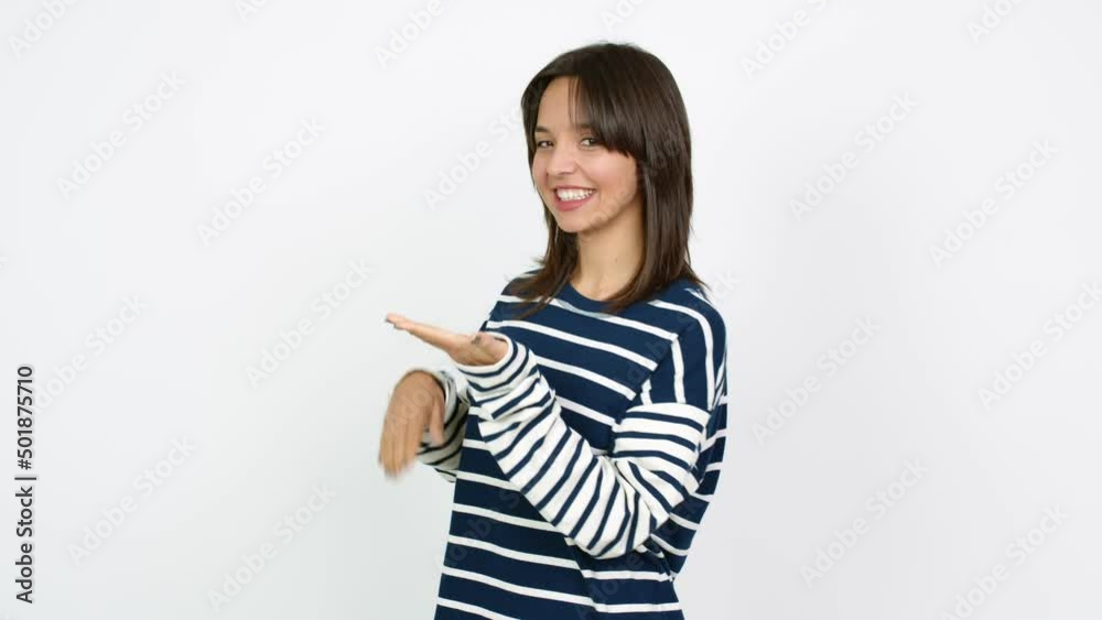 Young brunette woman extending hands to the side and inviting to come over isolated background Young brunette woman extending hands to the side and inviting to come over isolated background