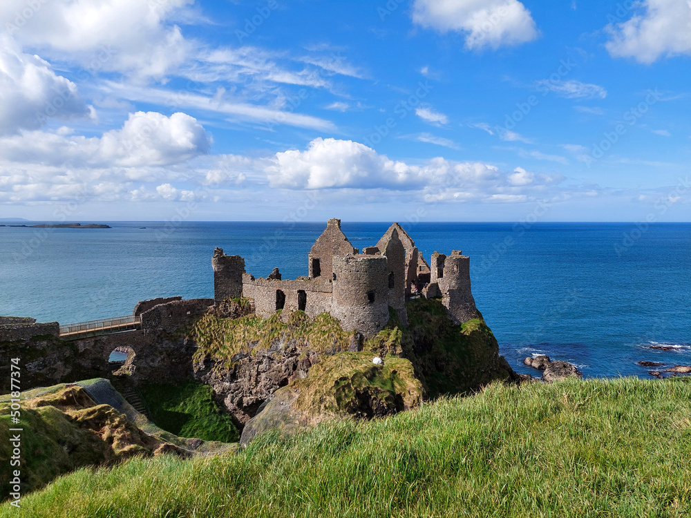 Dunluce castle, in Northern Ireland, United Kingdom. It's an abandoned, now-ruined medieval castle, the seat of Clan McDonnell, built on the edge of a basalt outcropping in County Antrim 