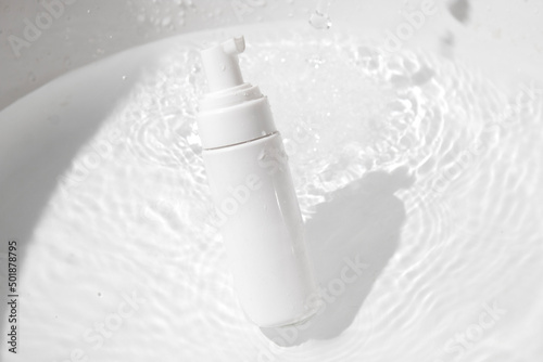 mockup of medical skin care bottle cosmetic tube of beauty makeup facial, treatment cleanser face foam, beauty healthcare branding packaging in water splash photo
