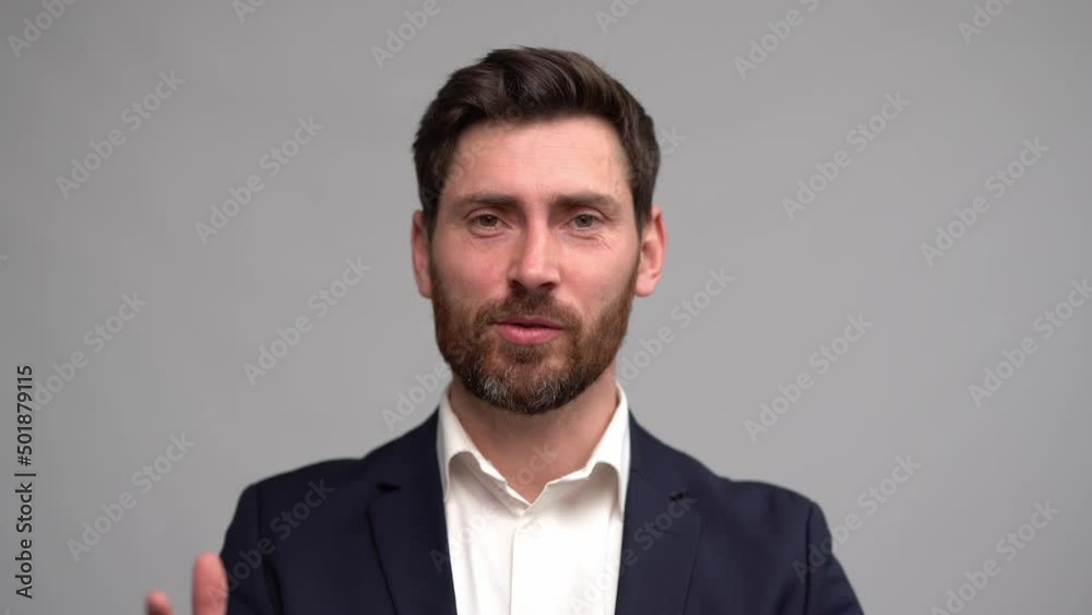 Man in business suit talking to camera actively gesticulating, coach keeping online lection