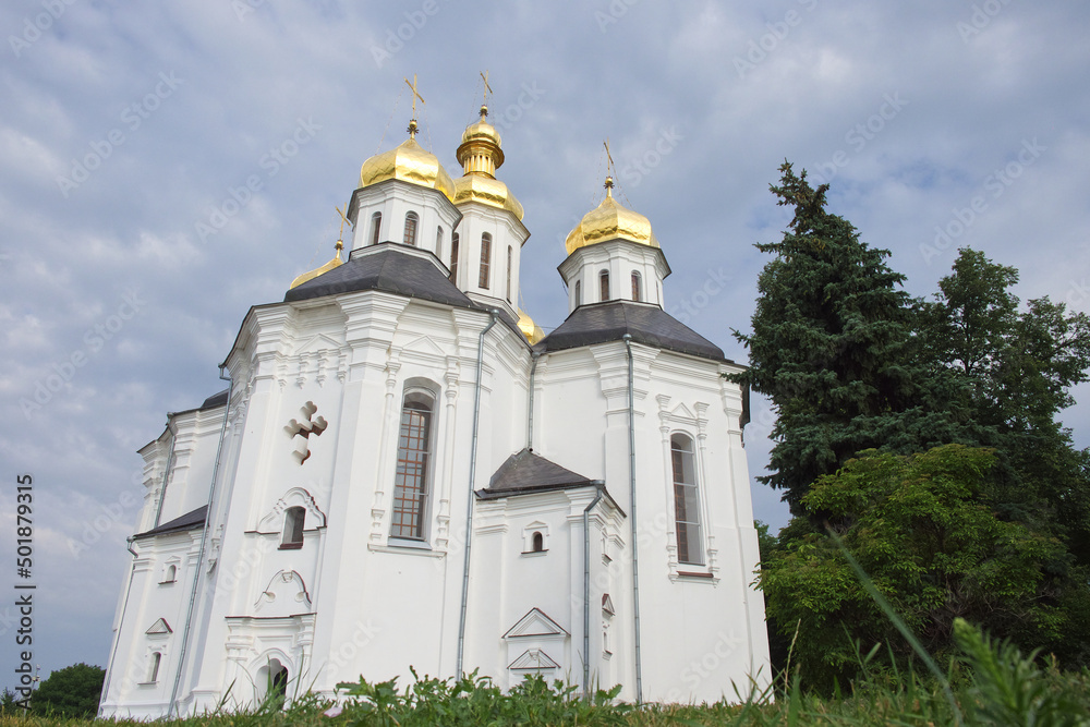 Cloudy sky over the ancient Orthodox Church of St. Catherine in the Ukrainian city of Chernihiv. An example of baroque architecture. Church is distinguished by its five gold domes.