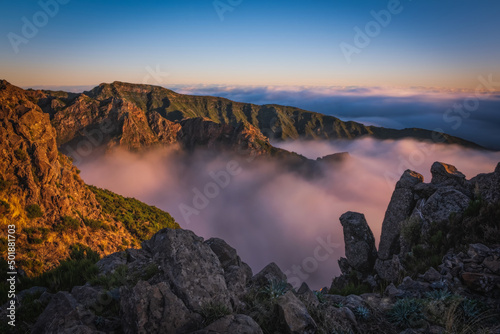 Mountain trail Pico do Arieiro, Madeira Island, Portugal Scenic view of steep and beautiful mountains and clouds during sunrise. October 2021
