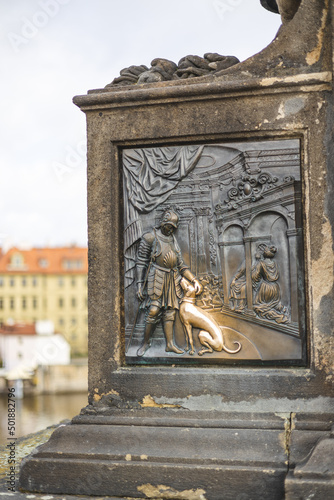 relief with soldier patting the dog on relief on statue of John of Nepomuk, Charles Bridge, Prague, Czech Republik