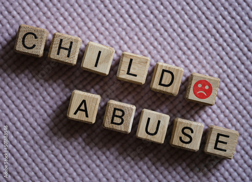 Text child abuse and angry smiley closeup