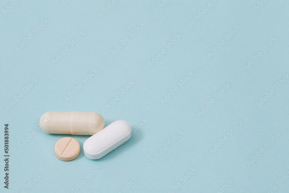 close up macro Pill spilling out disrupted. colorful pills capsule on to surface tablets on a white background. drug medical healthcare concept. close up macro Pill spilling out disrupted. colorful pills capsule on to surface tablets on a white background. drug medical healthcare concept.