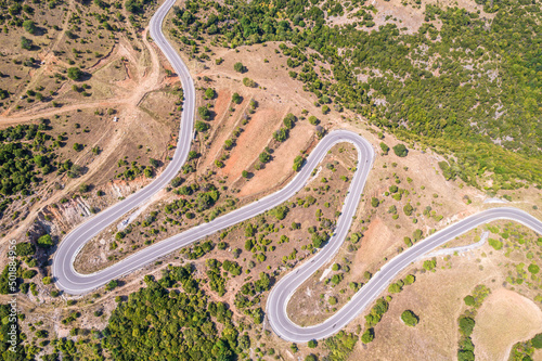 Meandering serpentine road in the mountain. Aerial view. Copter, drone view © flowertiare