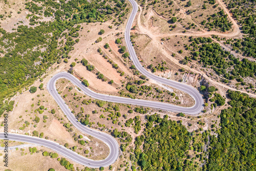 Meandering serpentine road in the mountain. Aerial view. Copter, drone view © flowertiare