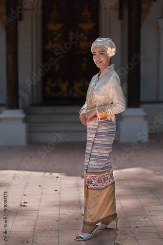 Beautiful Asian women dressed in traditional costumes visit Wat Palad or Wat Pha Lat temple ancient temples pray to the sacred according to Buddhist beliefs in Chiang Mai, Thailand. photo