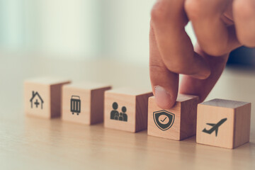 Travel safety and travel insurance concept. Wooden cubes with protect safety travel icon. Intended to cover medical expenses, trip cancellation, lost luggage and other losses incurred while traveling.
