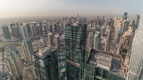 Panorama showing Dubai Marina and JLT with JBR district. Ttraffic on highway between skyscrapers aerial timelapse.