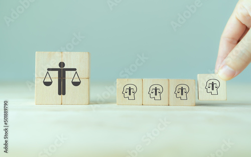 Ethical corporate culture concept. Ethics inside human mind. Business integrity and moral. Putting wooden cubes with ethics inside a head standing with ethical corporate. Sustainable business.