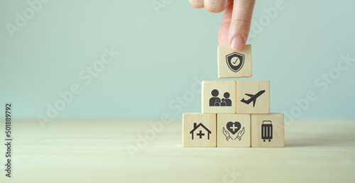 Travel safety and travel insurance concept. Wooden cubes with protect safety travel icon. Intended to cover medical expenses, trip cancellation, lost luggage and other losses incurred while traveling. photo