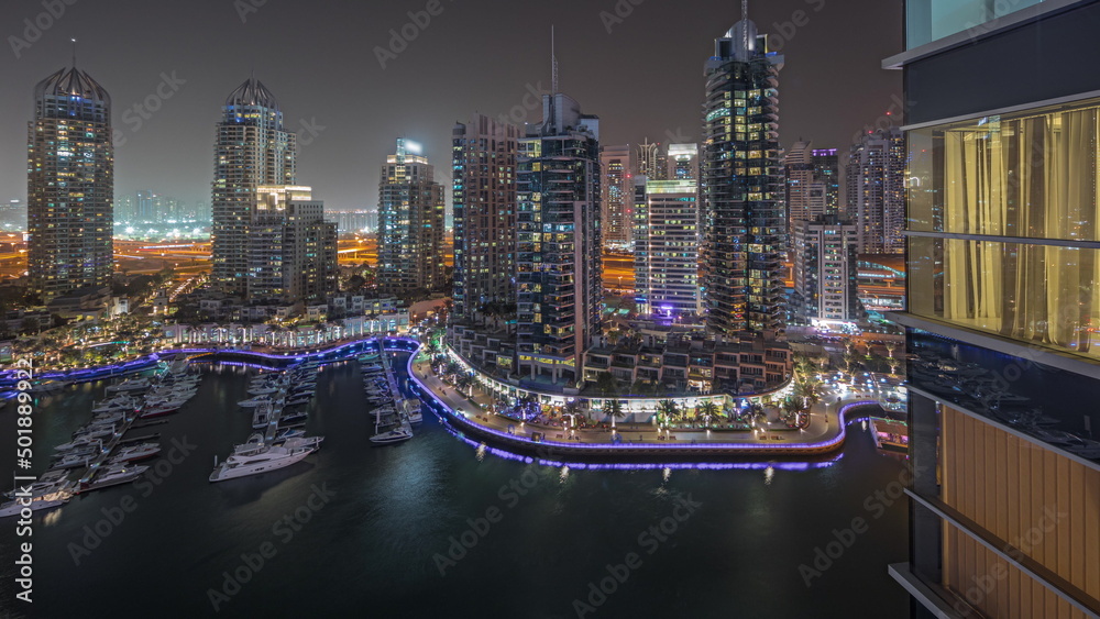 Naklejka premium Panorama showing luxury yacht bay in the city aerial night timelapse in Dubai marina