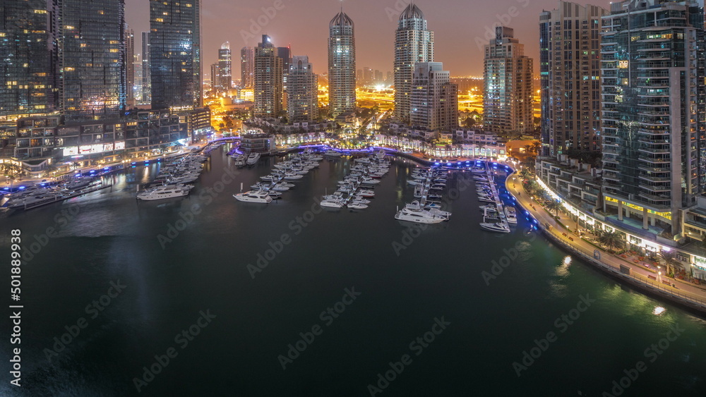 Obraz premium Luxury yacht bay in the city aerial night to day timelapse in Dubai marina