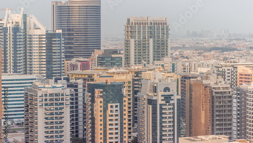 Skyscrapers in Barsha Heights district and low rise buildings in Greens district aerial timelapse. Dubai skyline