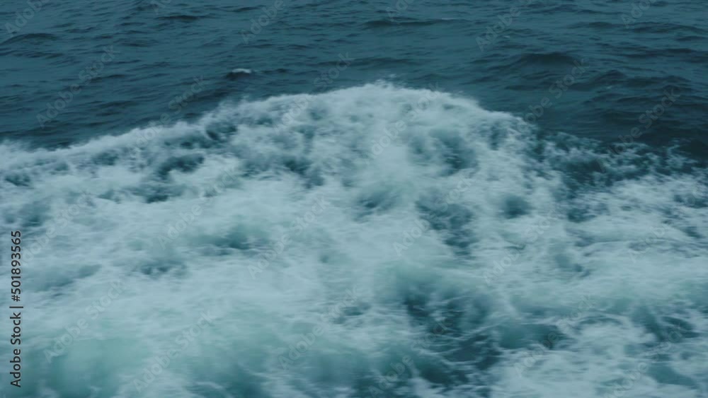 Waves flow from the wake of a ship as it travels through the water. Waves flow from the wake of a ship as it travels through the water.