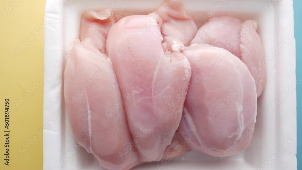 raw chicken breast in a packet on table raw chicken breast in a packet on table