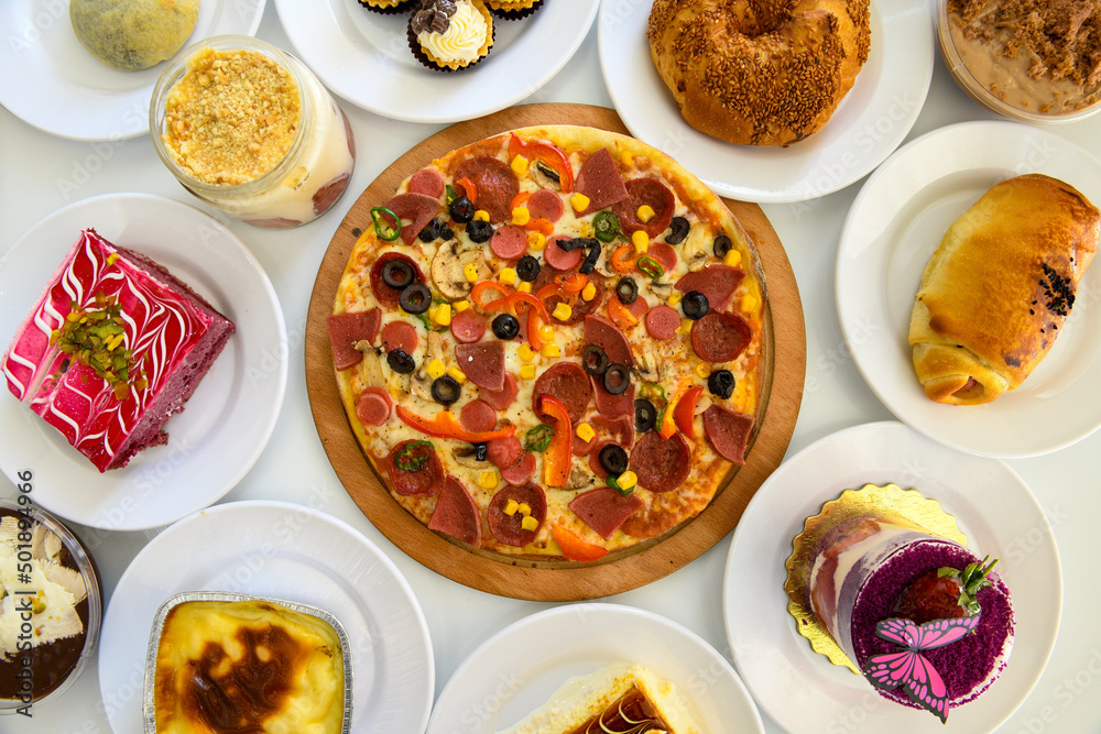 Traditional Turkish cuisine. Pizza, pita, pidesi, sucuk, hummus, kebab. Many dishes on the table. Serving dishes in restaurant. Background image. Top view, flat lay Traditional Turkish cuisine. Pizza, pita, pidesi, sucuk, hummus, kebab. Many dishes on the table. Serving dishes in restaurant. Background image. Top view, flat lay