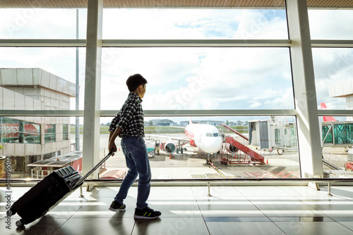 Young Air Traveller Walking To Boarding Gate Of An Airport photo