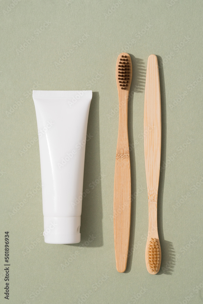 Vertical image of wooden bamboo toothbrush and tube with organic ...