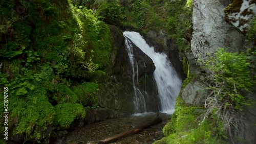 Panoramic landscape video of a large beautiful waterfall. Panoramic video with a breathtaking flight of the camera over the seething streams of a high waterfall.