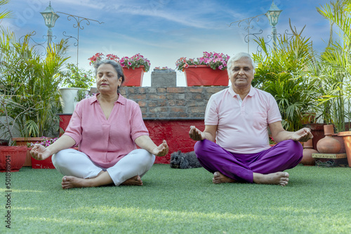 indian senior people doing yoga pose mediation 