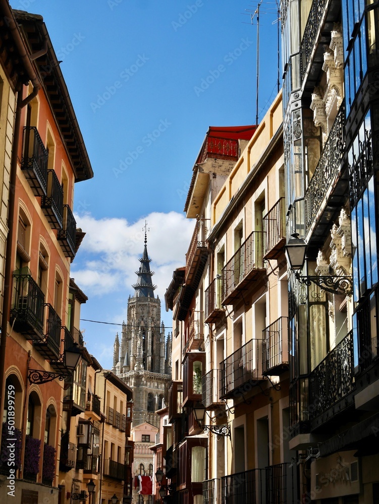 Streets of Toledo with Primada Santa Maria de Toledo Cathedral in the background. Spain.