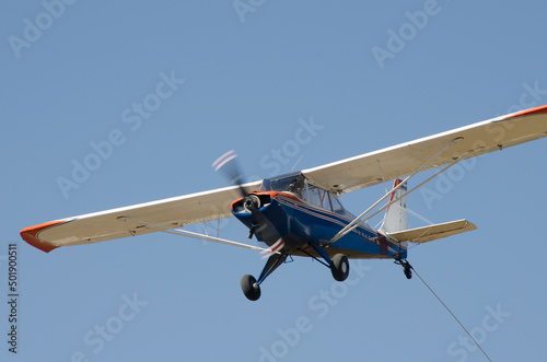 light aircraft flying, propeller plane flying towing ultralight glider © Lautaro