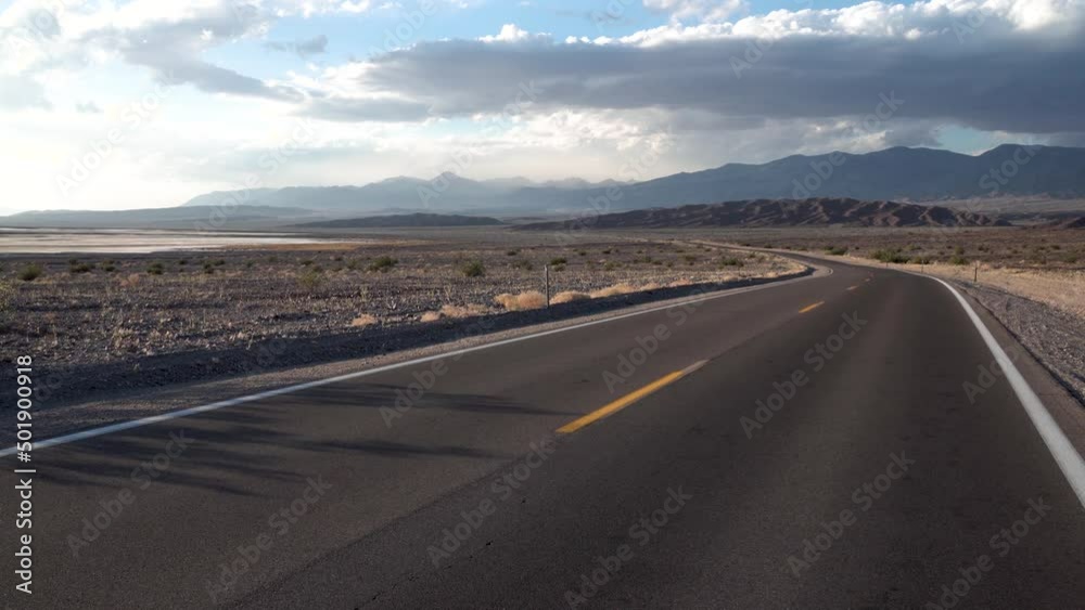 Lone highway with turn crossing Death Valley, Mojave Desert, California, Dolly left shot Lone highway with turn crossing Death Valley, Mojave Desert, California, Dolly left shot