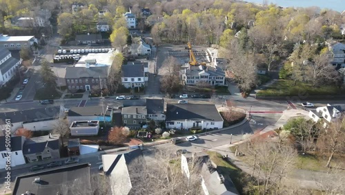 Drone slider right to left (truck left) over quaint village in New England. Roadways, cars, churches, buildings and activity shown. photo