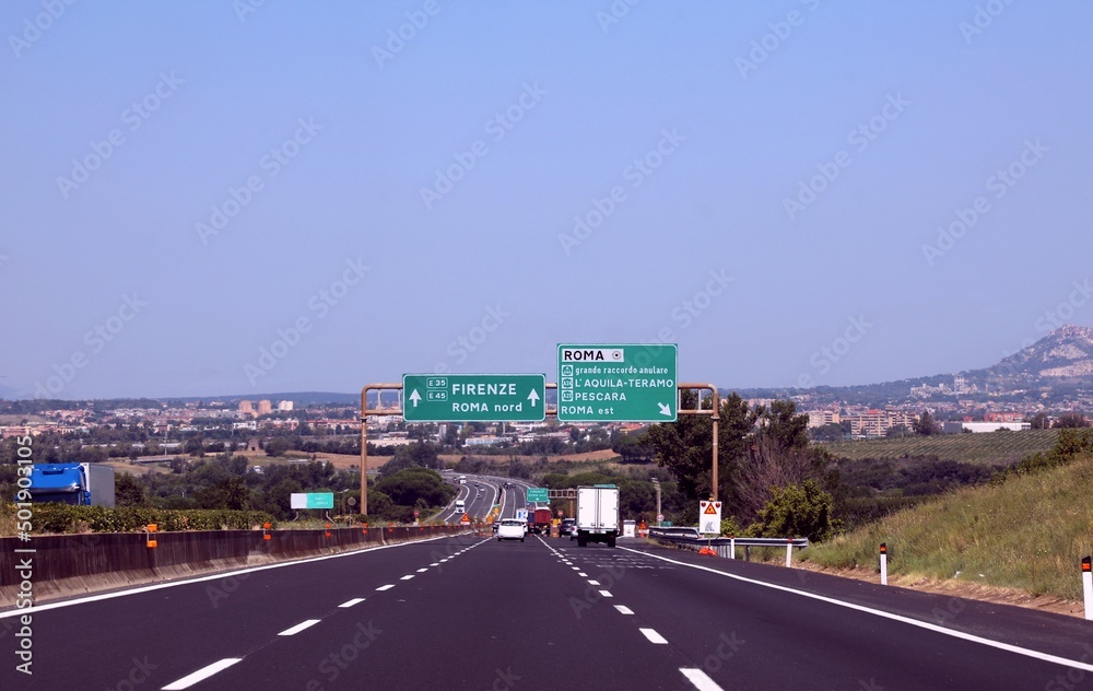 Crossroads with motorway sign with directions to the Italian cities Florence Rome Teramo and other places
