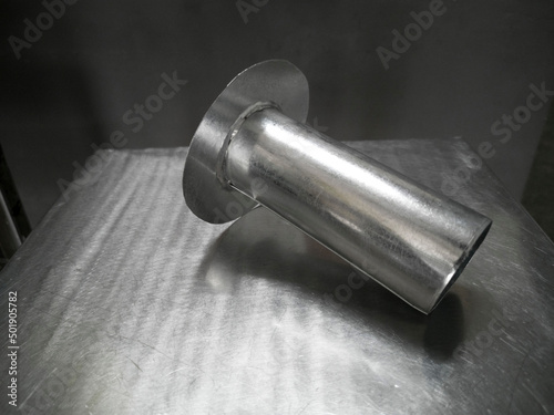 Downspout Funnel for Downpipe, Galvanized steel Funnel is put on the stainless table, photo is Depth of Field style
