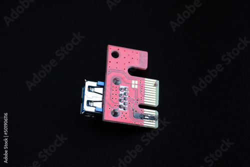 Burnt, damaged Riser PCI, on a dark background