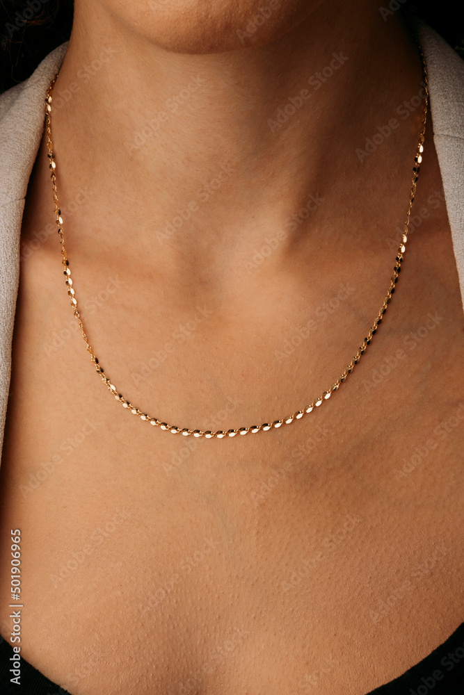 stylish elegant gold necklace on young girl's neck