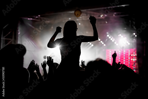 Black silhouette of crowd at concert - enjoy summer music festival.