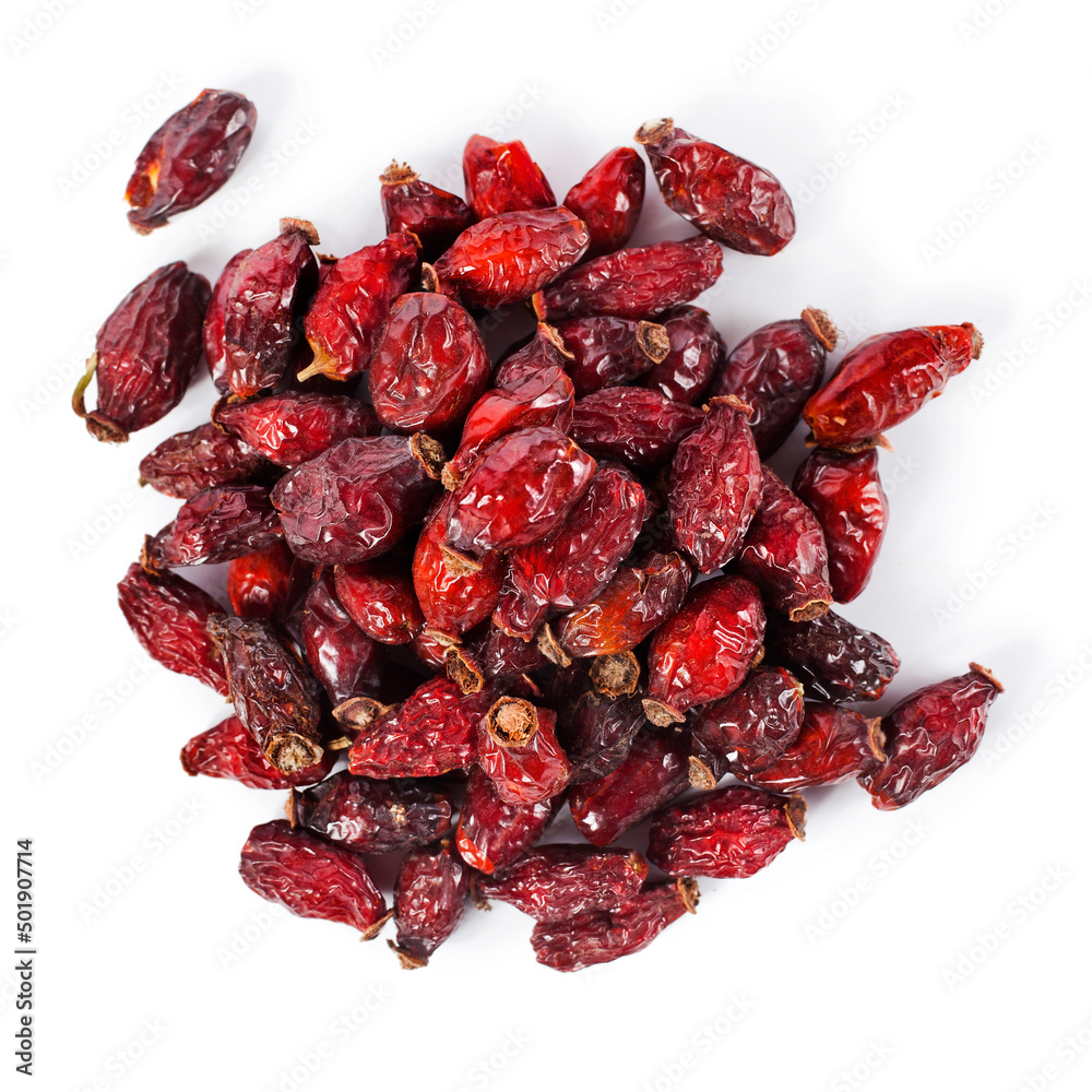 Heap of red dry rose hips isolated on a white background. Top view. Heap of red dry rose hips isolated on a white background. Top view.