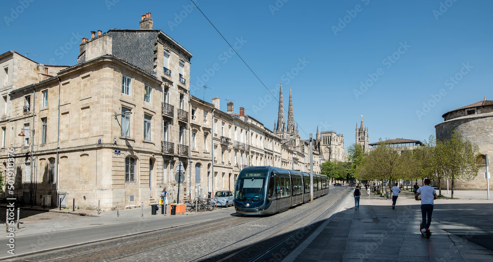 tramway passing through the streets of Bordeaux with the Cathedral in the background