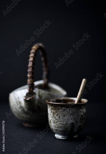 Traditional, handcrafted ceramic on dark background. Soft focus. Close up. Copy space.