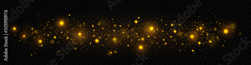 Golden shimmering background with light effect. The dust sparks and golden stars shine with special light on a transparent background. Christmas concept.