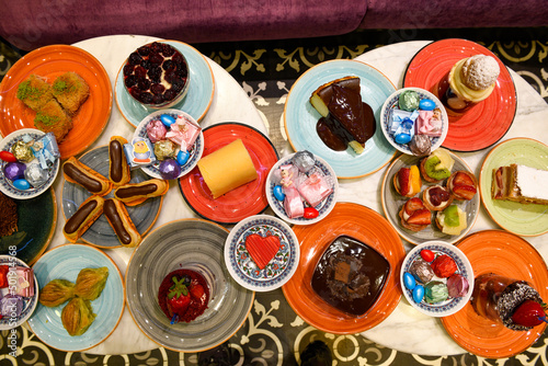Table scene of assorted take out or delivery foods. Traditional Turkish cuisine. Various Turkish desert and cake. Top down view on a table.