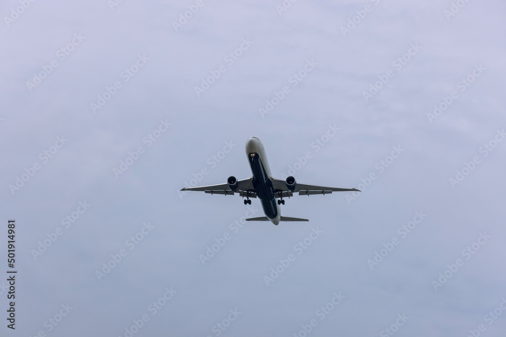 Airplane view over sky, the plane is landing at airport Airplane view over sky, the plane is landing at airport