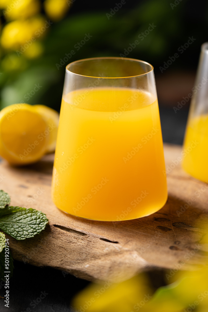 Orange juice glass jar shot on rustic wooden table Orange juice glass jar shot on rustic wooden table