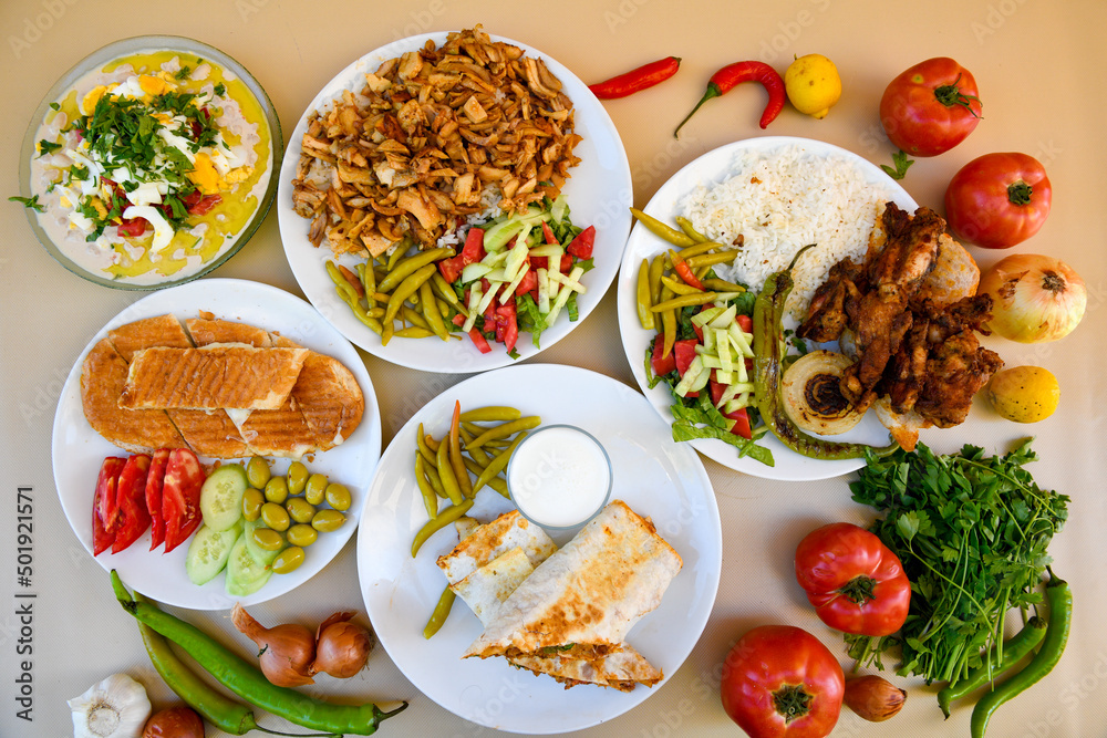 Table scene of assorted take out or delivery foods. Traditional Turkish cuisine. Various Turkish meal and appetizers. Top down view on a table. Table scene of assorted take out or delivery foods. Traditional Turkish cuisine. Various Turkish meal and appetizers. Top down view on a table.