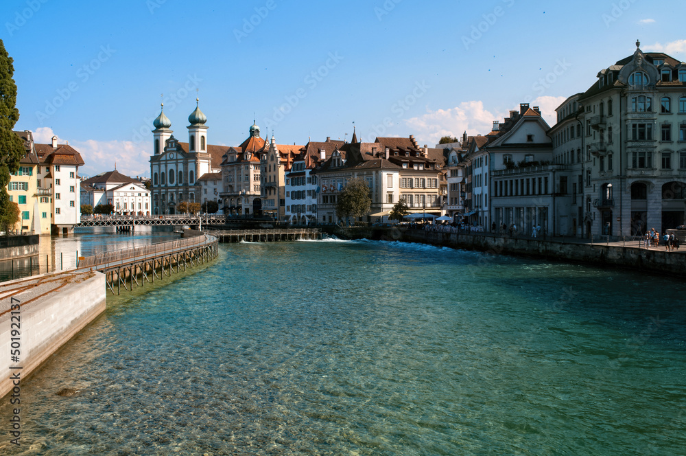 Lucerne, Switzerland - old wooden bridge and buildings on the lake embankment