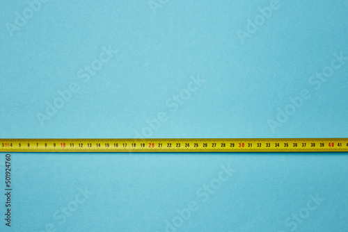 measuring tape on a blue background