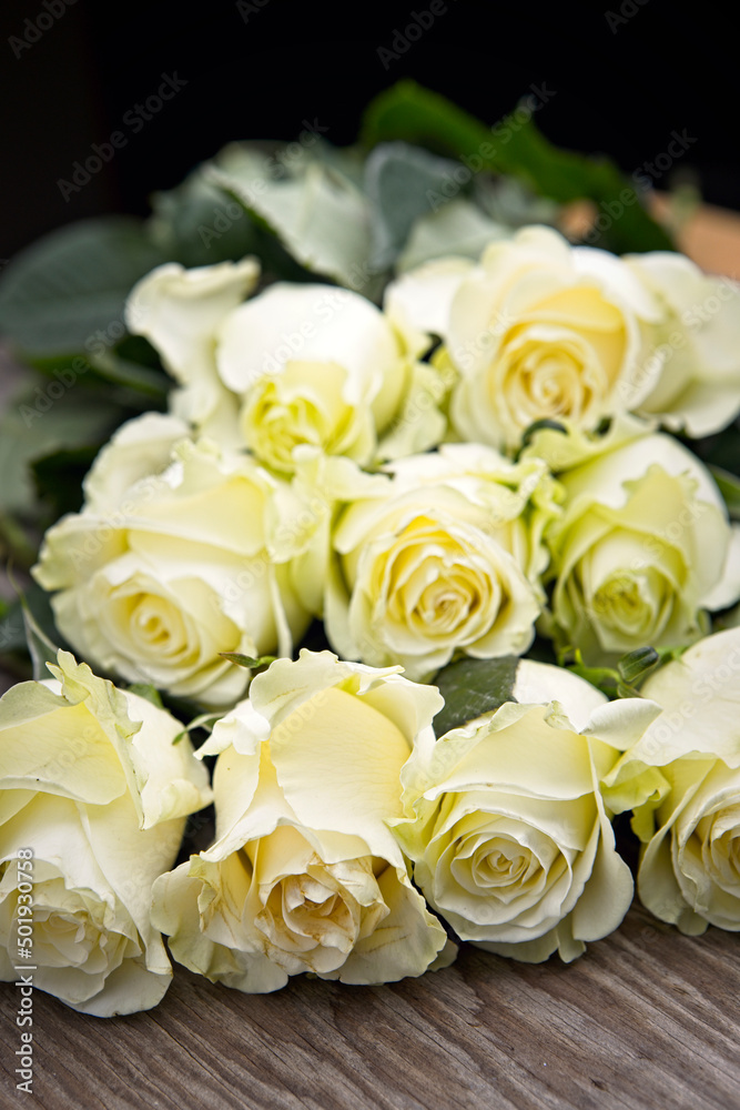 Obraz premium Roses stacked up on a table.